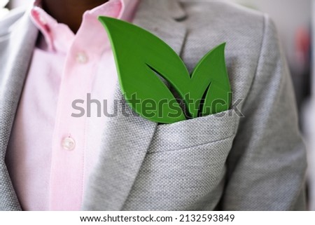 Man With Renewable Green Energy Sign Concept In Suit