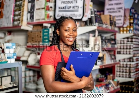 Black Women owning small business posing looking at the camera holding a a clipboard with hand crossed . Business concept Royalty-Free Stock Photo #2132602079