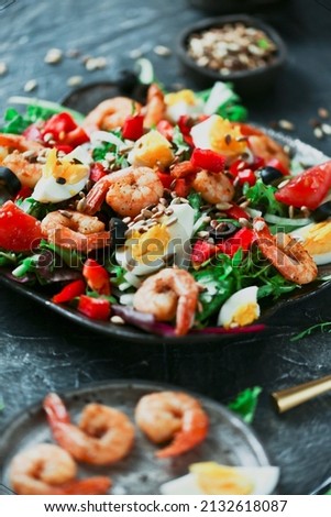 Healthy salad with prawns and vegetables. Delicious salad dressing. Aromatic salad for lunch. Royalty-Free Stock Photo #2132618087