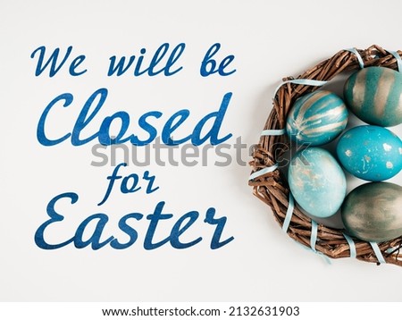 Signboard with the inscription We will be closed for Easter. Easter eggs painted with colorful paints. Closeup, indoors, no people. Congratulations for loved ones, relatives, friends, colleagues
