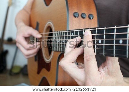 F minor 7 chord closeup fretboard learning acoustic guitar  Royalty-Free Stock Photo #2132651923