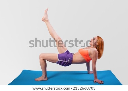 Beautiful girl is engaged in yoga, on a gray background. High quality photo