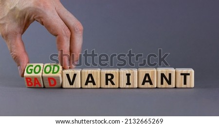 Good or bad variant symbol. Businessman turns cubes and changes words bad variant to good variant. Beautiful grey table grey background. Business good or bad variant concept, copy space.