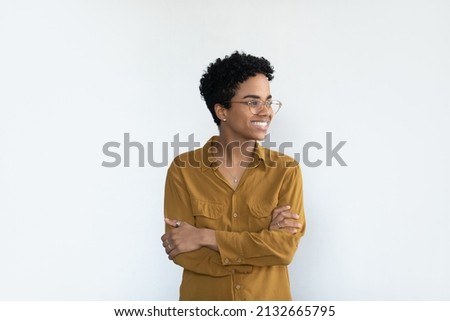 Happy confident young Black business woman professional head shot portrait. Female African business leader looking away with toothy smile, thinking, posing isolated at white background
