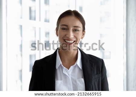Head shot portrait of smiling beautiful young Caucasian ambitious businesswoman worker in formal wear. Profile photo of attractive 30s female team leader manager employee or company representative.