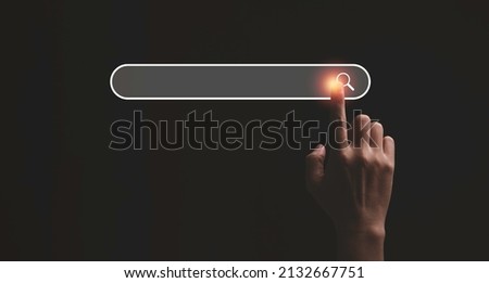 Hand touching with search icon for Search Engine Optimisation or SEO concept to find information by internet connection.