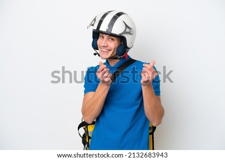 Young caucasian man with thermal backpack isolated on white background making money gesture