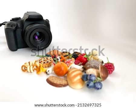 The camera is black in the process of shooting small objects on a white isolated background