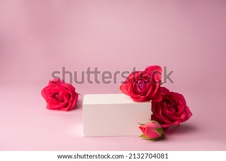 Podium for product photo background with roses. geometric objects and flowers.
