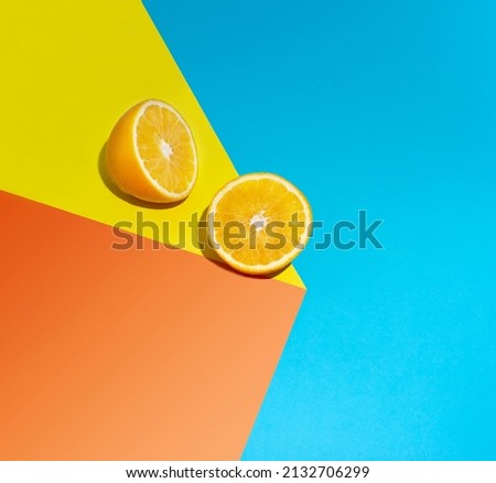 falling orange slices from the table on a blue background. The concept of minimum summer.