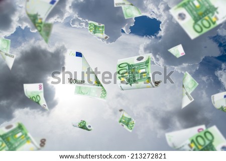 Euro banknotes falling down on cloudy sky background.