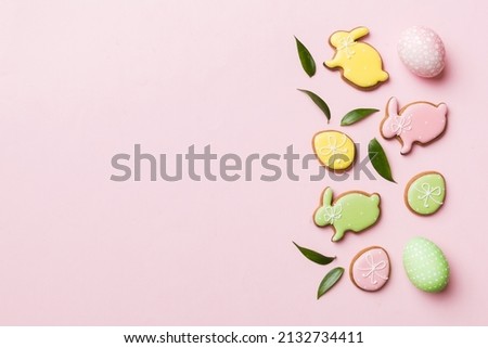 holiday preparation Multi colors Easter eggs with cookies on colored background . Pastel color Easter eggs. holiday concept with copy space.