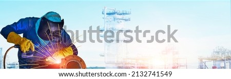 Banner worker welder is Welding industrial on metal steel pipe repair with spark light wearing equipment protective leather glove welded mask, panorama copy space oil refinery plant background. Royalty-Free Stock Photo #2132741549