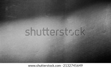 
Blurred paper black gray light background.
Grunge film grain effect distressed scary texture.