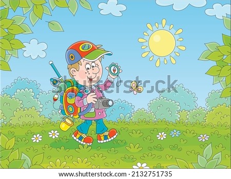 Cheerful little boy backpacker with his tourist compass and rucksack, friendly smiling and walking through a forest glade on a warm sunny day of summer vacation, vector cartoon illustration