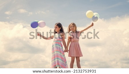 Cute and stylish. kid fashion. cheerful family day. fashion and beauty. sisterhood or friendship concept. smiling children with party balloons. childhood happiness. pretty teenage girls sisters