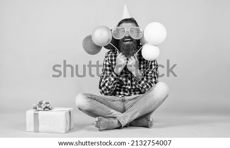surprise. happy man holding colorful helium balloons. hipster smiling happily. having fun on party. prepare for holidays. Event manager poses with festive accessory. fun and happiness concept
