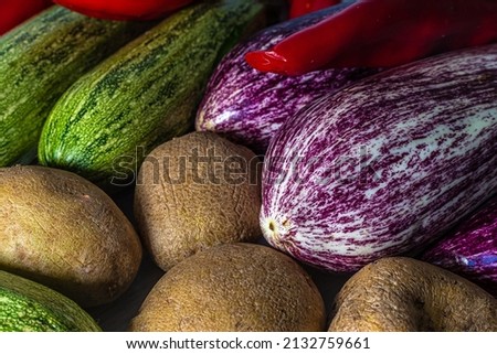 photo close up various fruits and vegetables. fresh food and healthy lifestyle. courgettes, potatoes, aubergines and peppers