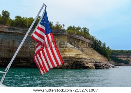 American Flag on a boat by the cliffs