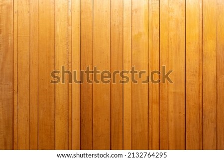 yellow vertical wooden wall There are different sizes of wood that are wide and narrow alternately installed. make the walls look warm Can be used to decorate the scene in the game or the picture insi