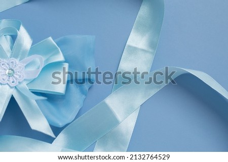 blue bow with a blue ribbon on a blue background