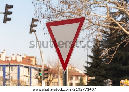 Give way sign or yield sign. Traffic sign and road safety information. Red metal board in highway.