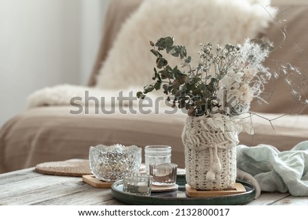 Cozy home background with dried flowers in a vase in the interior.