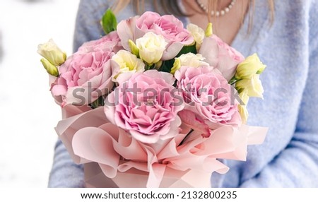 Close-up of a bouquet of roses in female hands. Royalty-Free Stock Photo #2132800235