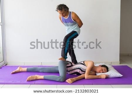 Thai Barefoot Massage technique for the glutes (buttocks). Hands-free massage. Male massage therapist, female client. Royalty-Free Stock Photo #2132803021