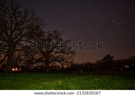 Starry night over small houses in countryside Royalty-Free Stock Photo #2132830587