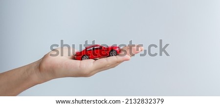 businessman hand holding red car toy. Car insurance, warranty, rental, Financial, new and repair concept Royalty-Free Stock Photo #2132832379