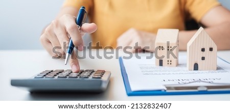 Woman using calculator during signing home contract documents. Contract agreement, real estate,  buy and sale and insurance concepts