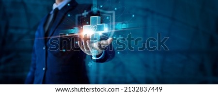Businessman hand holding virtual medical health care icons with medical shield and network connection. People health care awareness rising growth of medical health and life insurance business. Royalty-Free Stock Photo #2132837449
