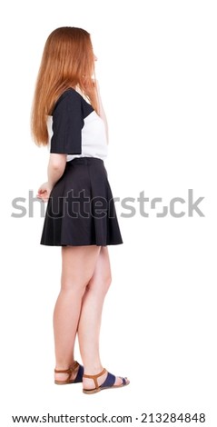 Back view of young redhead woman pointing at wall. beautiful girl in dress. Rear view people collection. backside view of person. Isolated over white background.