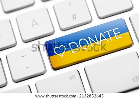 Keyboard key with Ukraine flag and donate text. donation for Ukraine concept Royalty-Free Stock Photo #2132852645