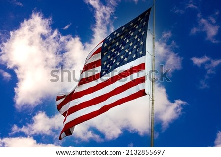 American flag against a blue sky with clouds freedom independence star