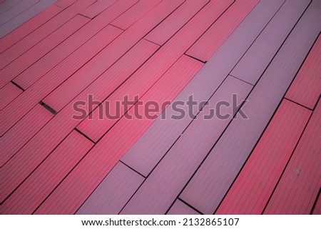 Cheerful pastel pink floor in the corner of the city. Wooden boards banners texture. wooden texture. Wood surface of floor or wall. Timber background.Background for greeting card, advertisement.
