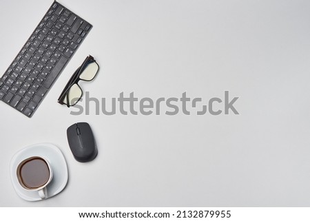 Bright office workspace. Work space with notepad, keyboard, coffee and glasses. Work space table desk. Flat lay, top view, copy space