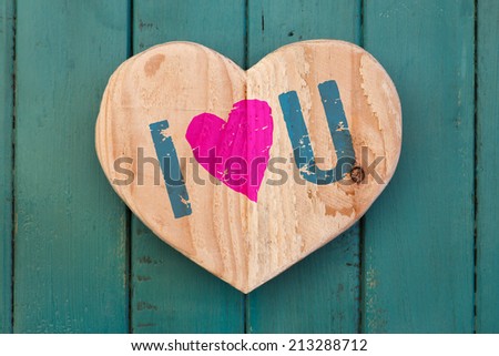 I love You Valentines message wooden heart from recycled old palette on turquoise painted background, copy space
