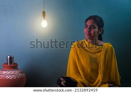 Teenage rural girl sitting at home and looking away Royalty-Free Stock Photo #2132892459