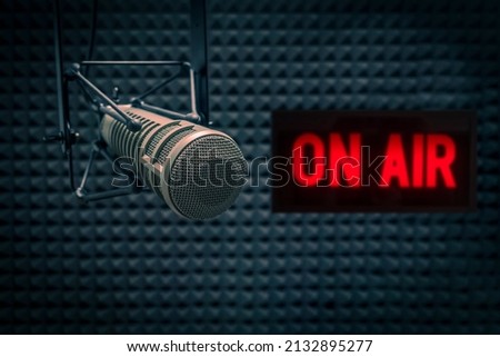 Professional microphone in radio station studio and on air sign Royalty-Free Stock Photo #2132895277