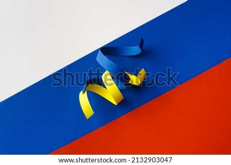 Blue and yellow ribbons as symbol of Ukraine on flag of Russia. Russian aggression concept