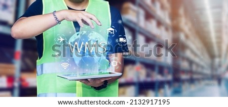 WMS,Smart warehouse management system.Worker hands holding tablet on blurred warehouse as background Royalty-Free Stock Photo #2132917195