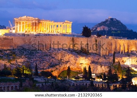 Famous skyline of Athens with Acropolis hill and Pathenon illuminated at night, Athens Greecer