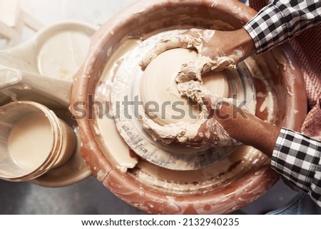 Experienced male potter working on pottery wheel