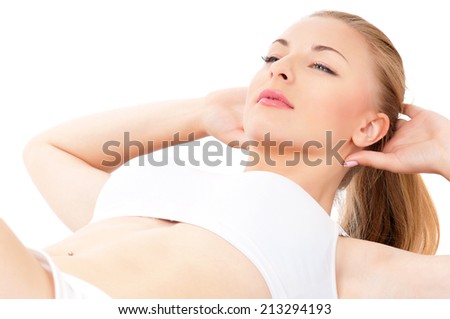Beautiful young woman doing fitness exercise on the floor, isolated on white background