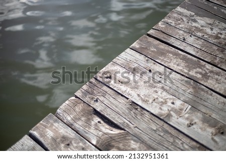 Detail of a wooden dock on the lake. Royalty-Free Stock Photo #2132951361