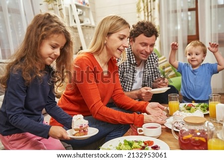 Parents with daughter and son eating at home