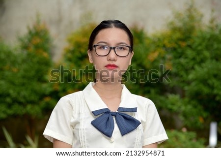 Unemotional Young Asian Person Wearing Glasses Royalty-Free Stock Photo #2132954871