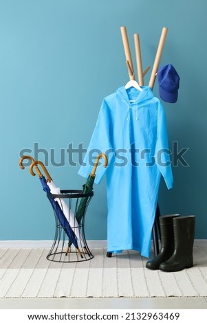 Raincoat, gumboots and umbrellas in hallway